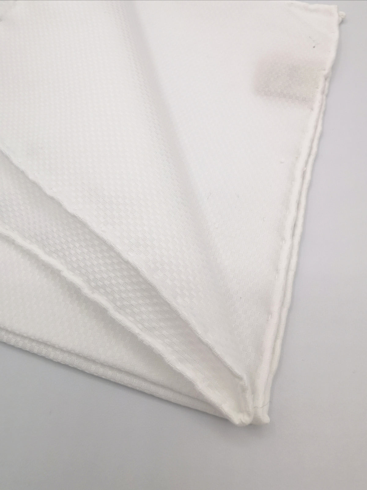 White cotton pocket square with checkerboard pattern